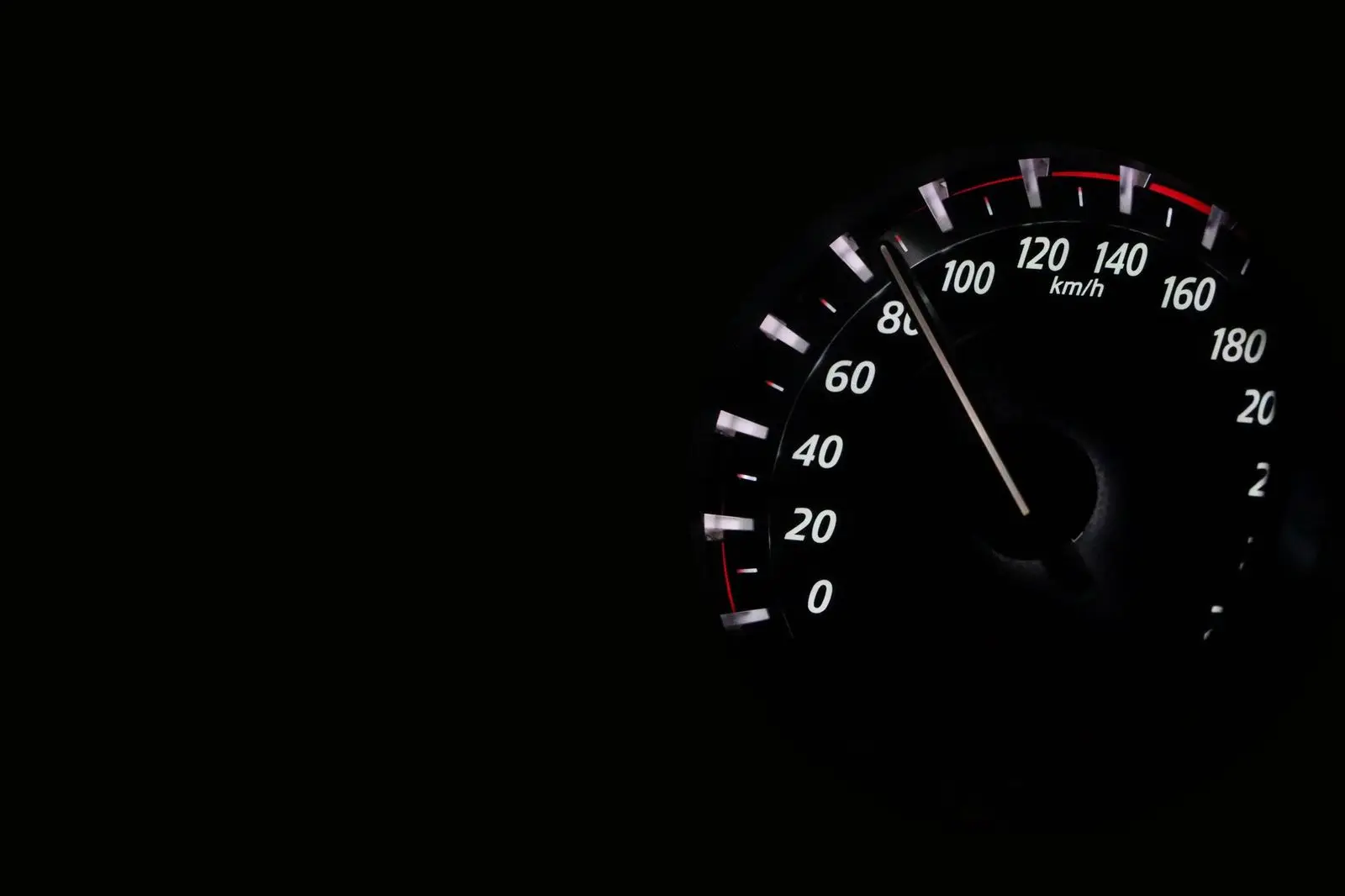 Close view of a car speedometer marked in kilometres per hour.