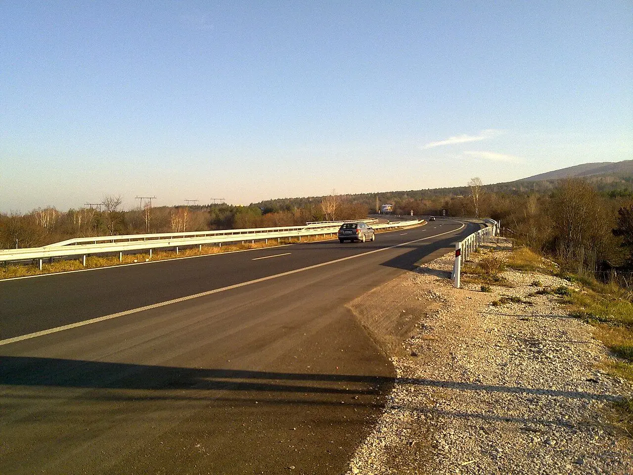 A car on the Trakia motorway near Sofia, guardrail along a gentle curve.