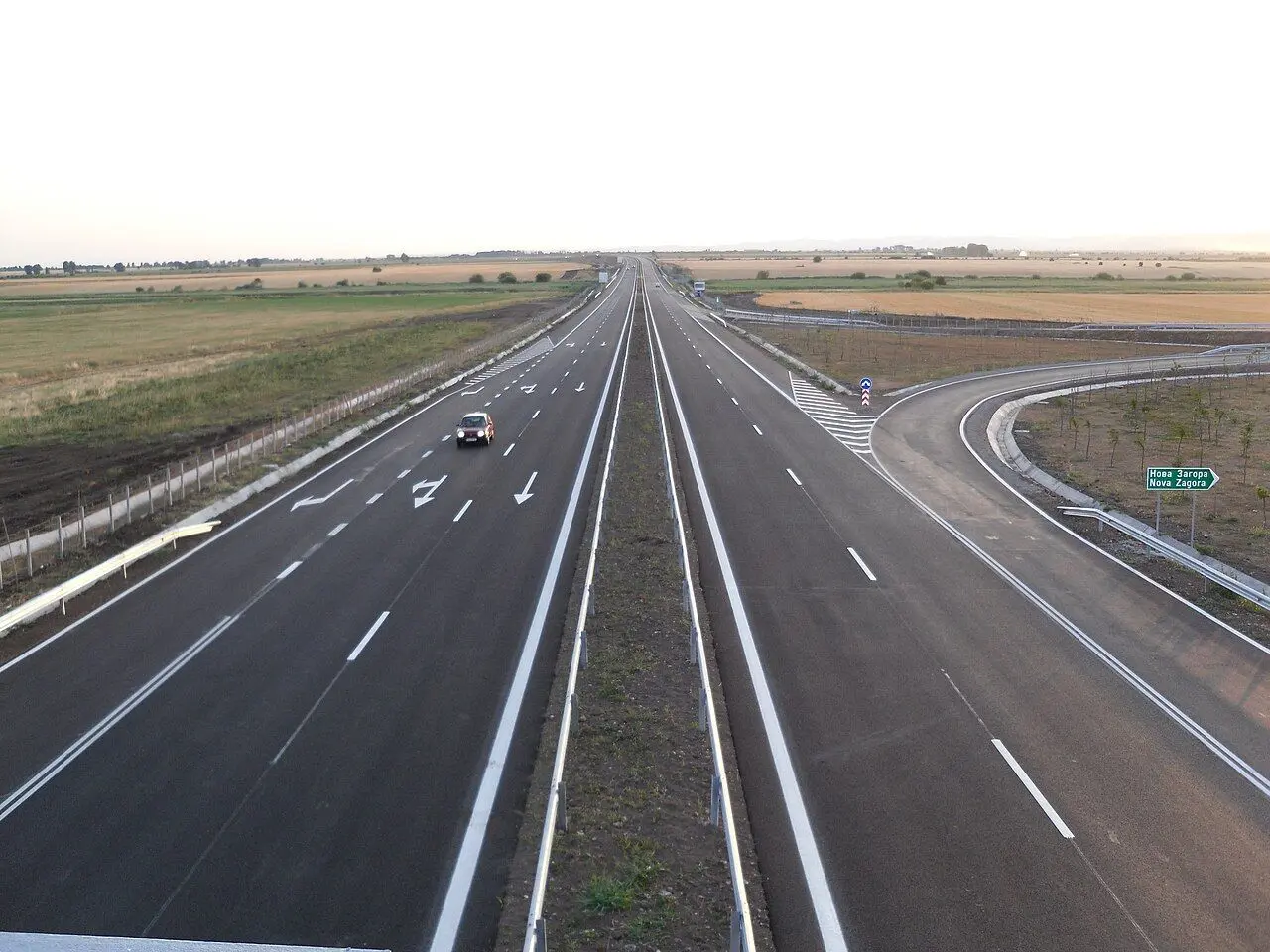 Trakia motorway near Nova Zagora, a wide dual carriageway through fields with a slip road to the right.